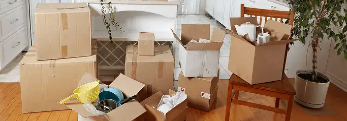 Packed moving boxes and household items in a kitchen before move-out or move-in cleaning, Hollywood, FL.